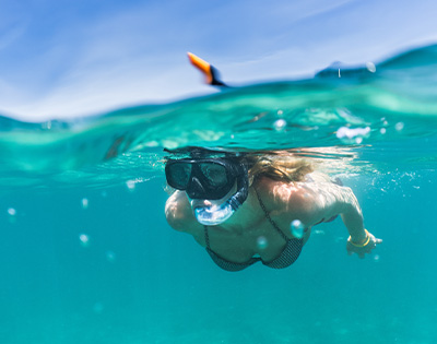 lady snorkelling in the ocean