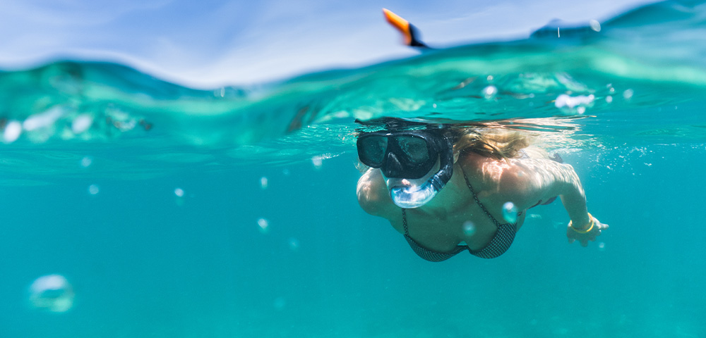 lady snorkelling in the ocean