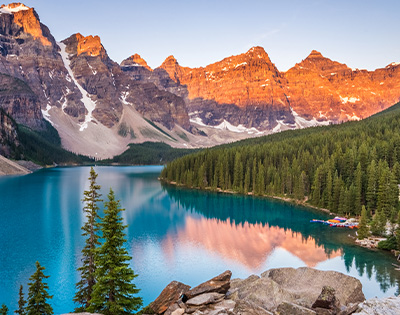 Emerald blue lake with alpine trees and rocky mountains at Moraine Lake Banff