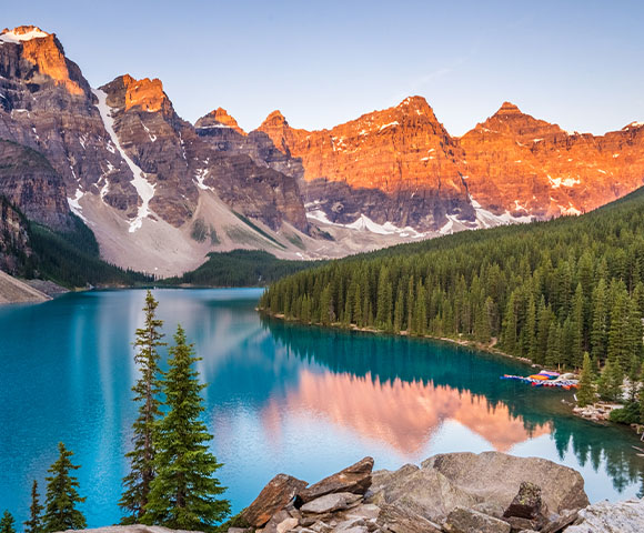 Emerald blue lake with alpine trees and rocky mountains at Moraine Lake Banff