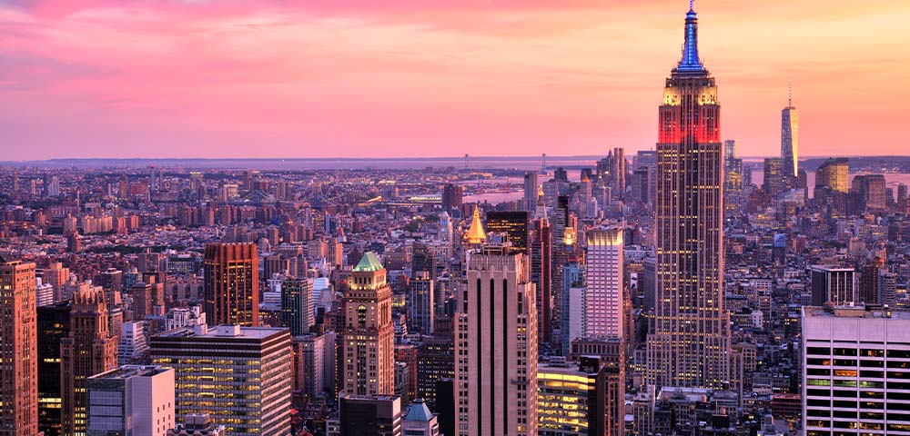 New York city skyline with Empire state building with pink and purple sunset