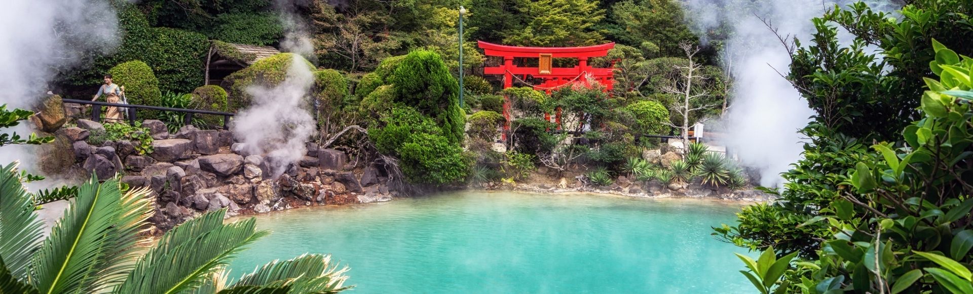 A serene hot spring surrounded by lush greenery and steam, with a red torii gate in the background.