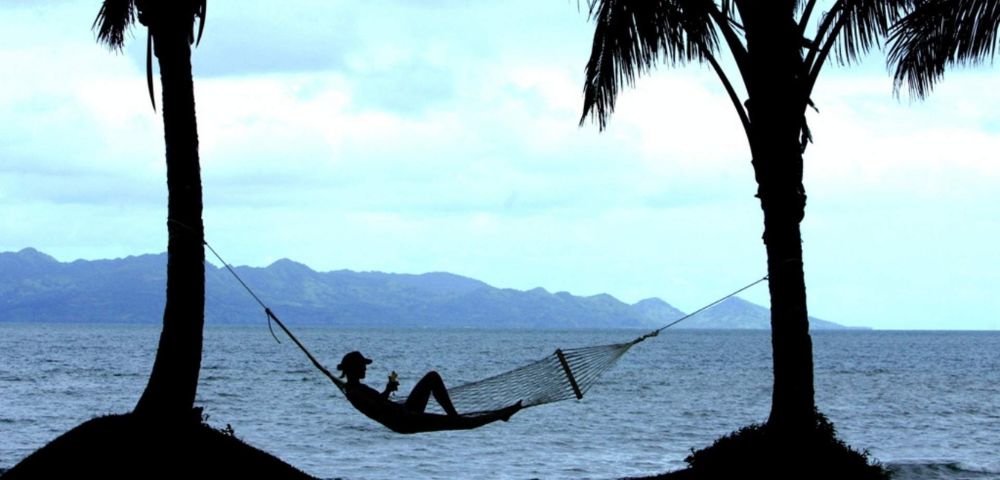 my-fiji-person-relaxing-in-hammock-on-the-beach-at-the-pearl-resort-spa-and-golf-course-in-beqa-lagoon