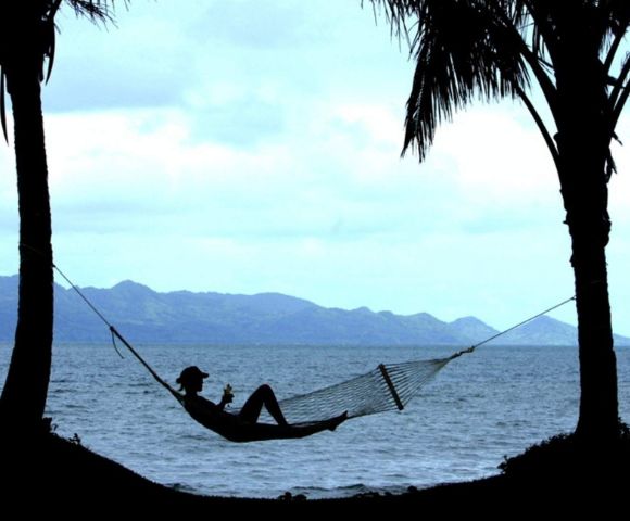 my-fiji-person-relaxing-in-hammock-on-the-beach-at-the-pearl-resort-spa-and-golf-course-in-beqa-lagoon