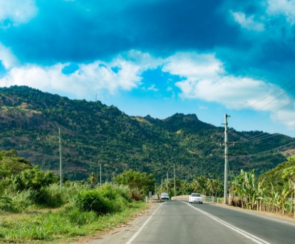 my-fiji-909908894-local-roads-with-mountains-in-distance-in-nadi