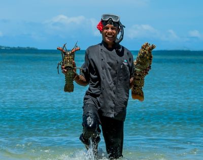 my-fiji-chef-holding-two-shellfish-fresh-from-the-water-at-first-landing-beach-resort-villas-in-lautoka