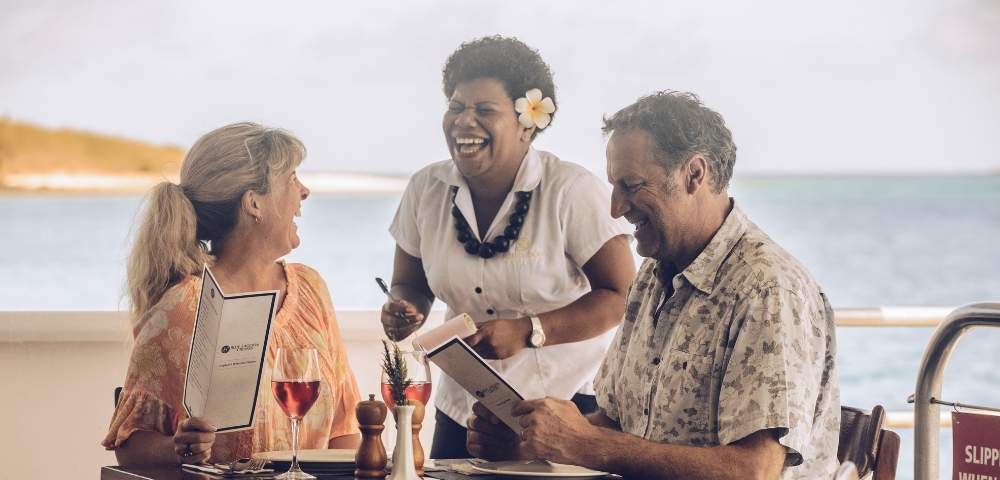 my-fiji-couple-laughing-with-staff-on-blue-lagoon-cruises-ship