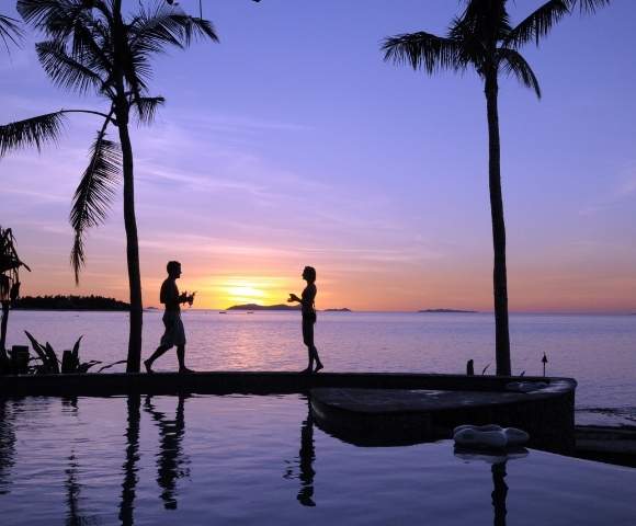 my-fiji-two-people-by-the-pool-at-sunset-at-treasure-island-resort