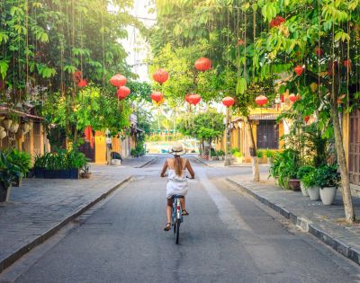 VIETNAM-HOI-AN-woman-on-bike-streets-GettyImages-1039021134-MY-HOLIDAY