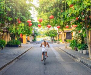 VIETNAM-HOI-AN-woman-on-bike-streets-GettyImages-1039021134-MY-HOLIDAY