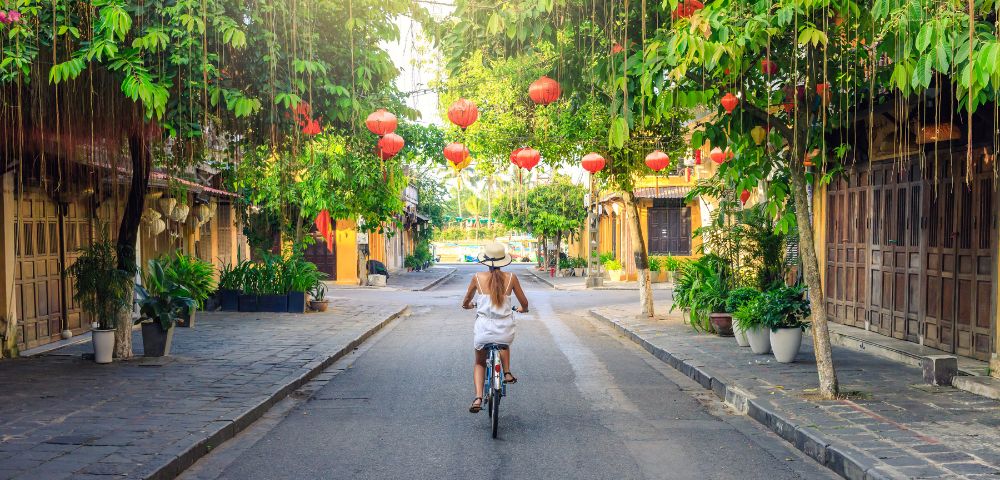 VIETNAM-HOI-AN-woman-on-bike-streets-GettyImages-1039021134-MY-HOLIDAY