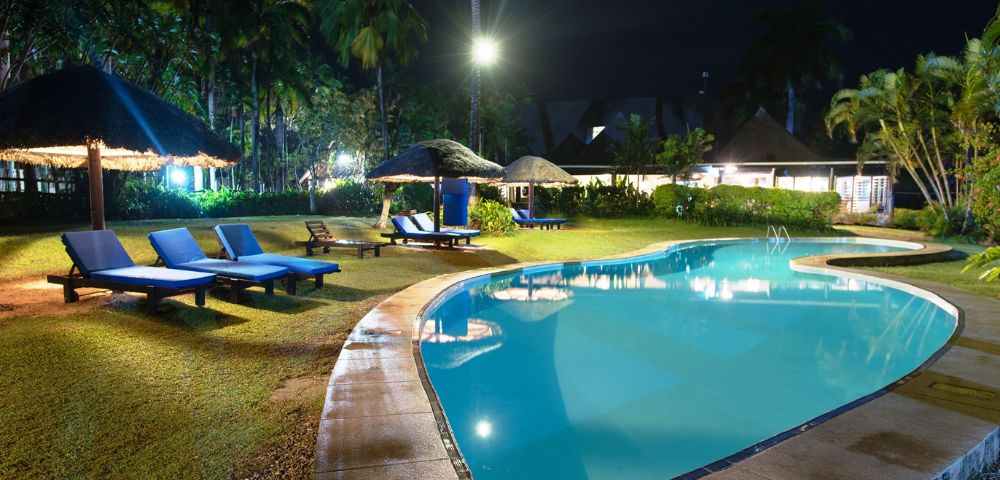 MY-HOLIDAY-Pool-and-lounge-chairs-at-night-at-Tambua-Sands-Beach-Resort