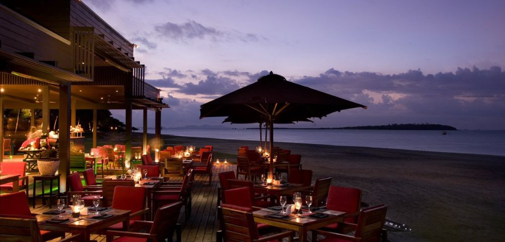 MY-HOLIDAY-Maravu-Restaurant-seating-area-and-beach-during-sunset-at-Hilton-Fiji-Beach-Resort-and-Spa