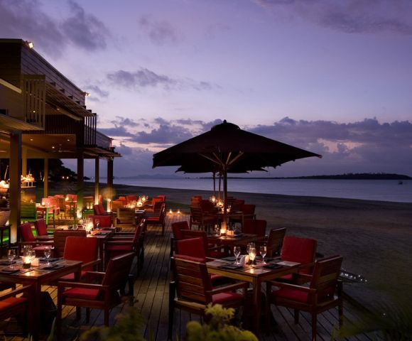 MY-HOLIDAY-Maravu-Restaurant-seating-area-and-beach-during-sunset-at-Hilton-Fiji-Beach-Resort-and-Spa