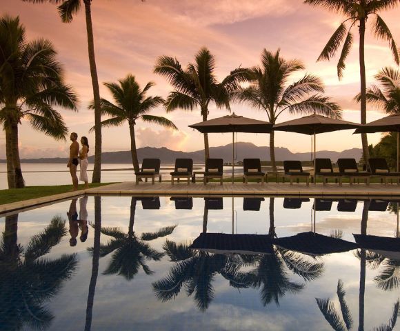 MY-HOLIDAY-Pool-and-lounge-chairs-during-sunset-at-Hilton-Fiji-Beach-Resort-and-Spa