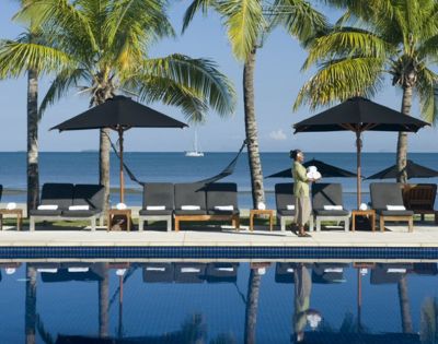 MY-HOLIDAY-Pool-lounge-chairs-and-housekeeper-at-Hilton-Fiji-Beach-Resort-and-Spa