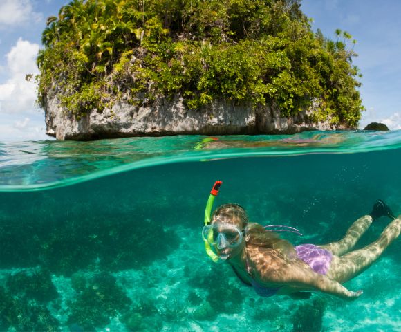 MY-HOLIDAY-woman-snorkeling-near-a-rock-island