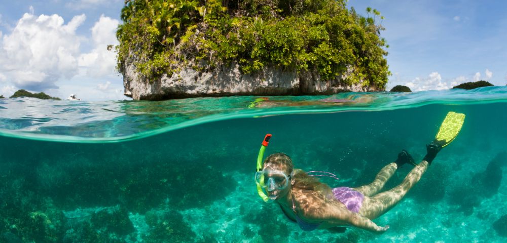 MY-HOLIDAY-woman-snorkeling-near-a-rock-island