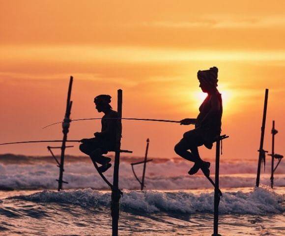 Sri Lanka men fishing by orange sunset