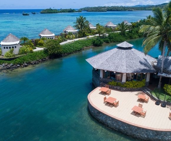 aerial shot of restaurant with tables set up on the patio overlooking the water