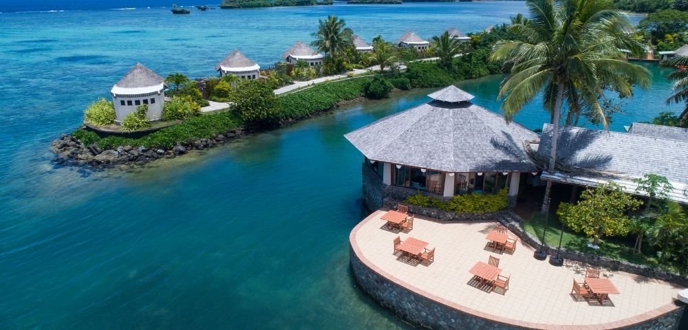 aerial shot of restaurant with tables set up on the patio overlooking the water