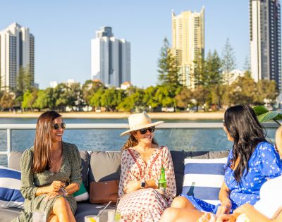 group of ladies sitting on the rooftop deck of the seaworld cruise with drinks