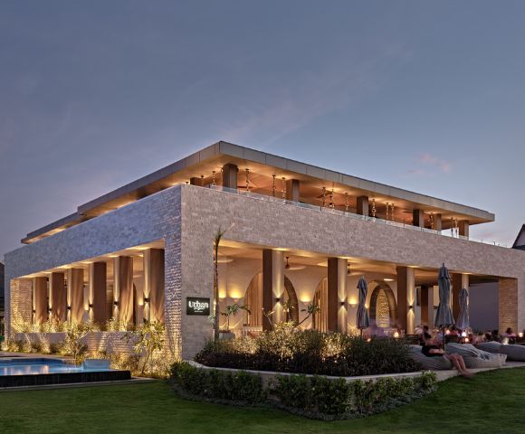 Crowne Plaza Fiji Nadi Bay Resort and Spa Modern outdoor restaurant at twilight with lit interiors and comfortable seating.