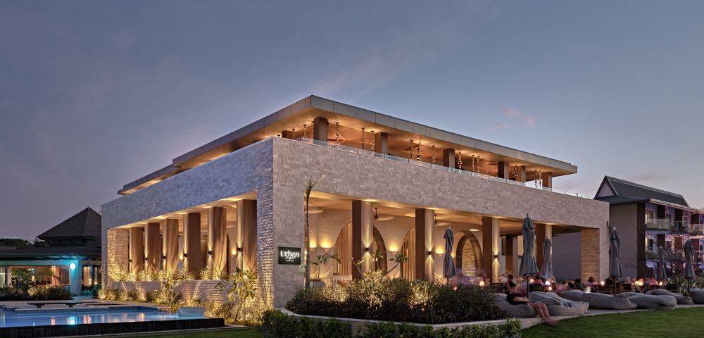 Crowne Plaza Fiji Nadi Bay Resort and Spa Modern outdoor restaurant at twilight with lit interiors and comfortable seating.