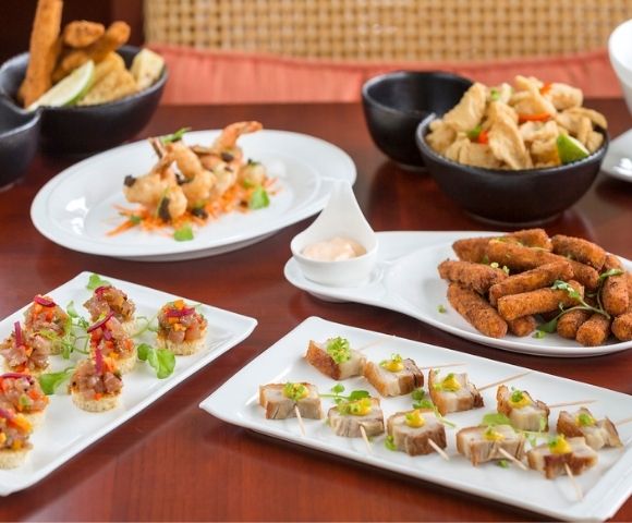 Assorted appetizers displayed on a table with a menu stand.