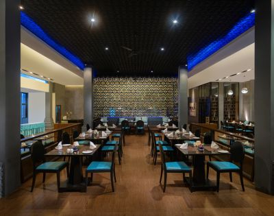 A dining area in a restaurant with blue chairs and tables, creating a vibrant atmosphere.