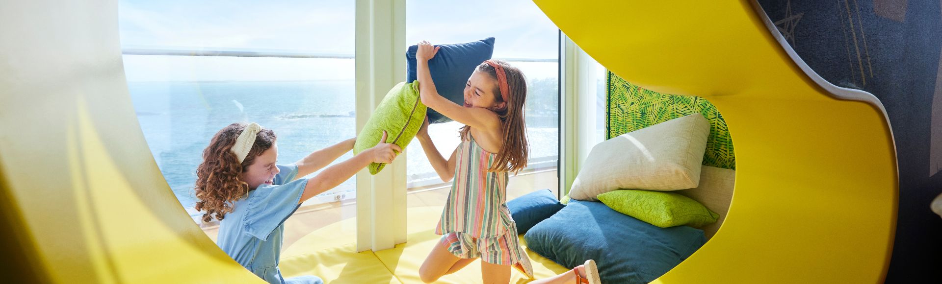 Two children playing in a colourful bed on Icon of the Seas