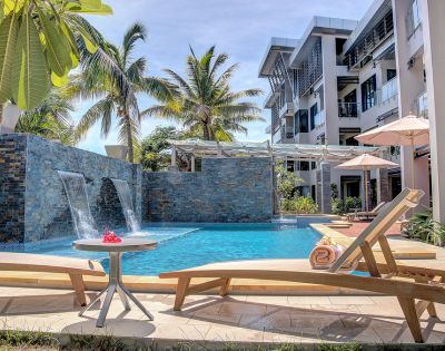 Tranquil poolside oasis with tropical foliage and modern architecture.