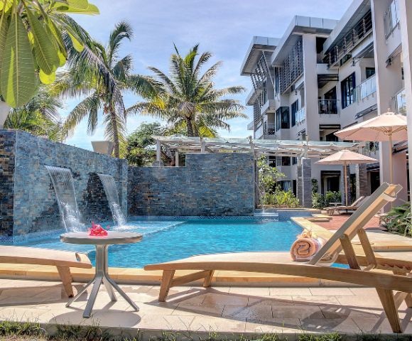 Tranquil poolside oasis with tropical foliage and modern architecture.