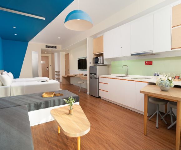 Modern, stylish studio apartment with a kitchen and living area.