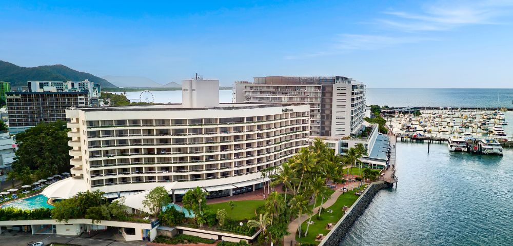 The Hilton Cairns Hotel, showcasing elegant architecture and lush surroundings, ideal for relaxation and leisure.
