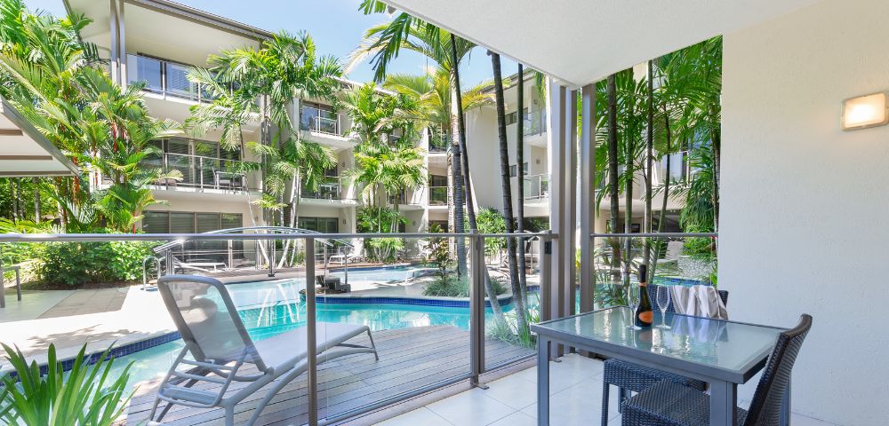 A balcony featuring a pool and a spacious patio area, ideal for relaxation and outdoor enjoyment.