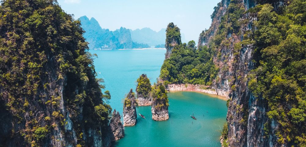Aerial view of Khao Sok National Park in Thailand, showcasing the limestone karsts and turquoise waters.