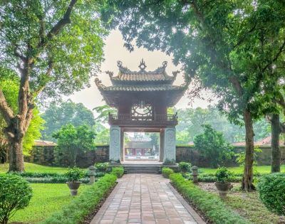 A serene view of Hanoi Temple of Literature and a green lush greenery sorrounding.