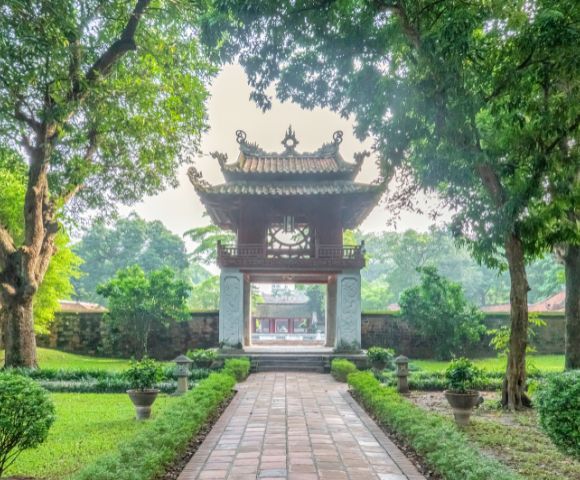 A serene view of Hanoi Temple of Literature and a green lush greenery sorrounding.