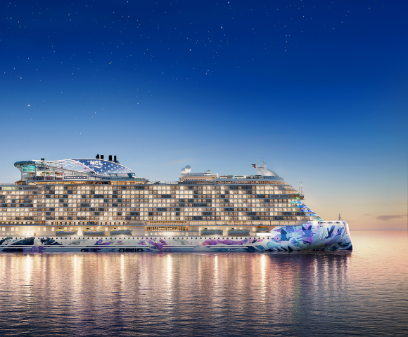 A colorful cruise ship floats on calm waters at sunset, featuring vibrant designs and illuminated windows against a twilight sky.