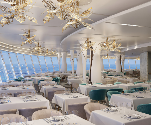 Elegant restaurant with modern decor, featuring butterfly chandeliers, white tablecloths, and panoramic ocean views.