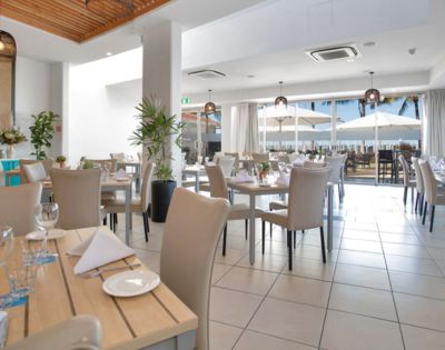 Indoor Dining Area – A spacious, well-lit dining room with neatly arranged tables and chairs.