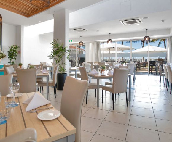 Indoor Dining Area – A spacious, well-lit dining room with neatly arranged tables and chairs.