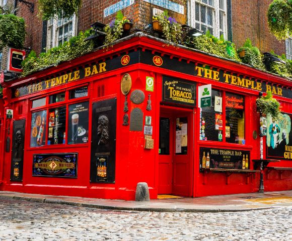 The Temple Bar, Ireland – A lively red-painted pub on a cobblestone street in Dublin, known for its iconic exterior and cultural charm.