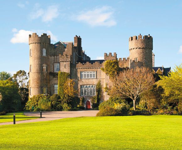 Malahide Castle, Ireland – A medieval castle surrounded by lush greenery and gardens in Dublin, Ireland.