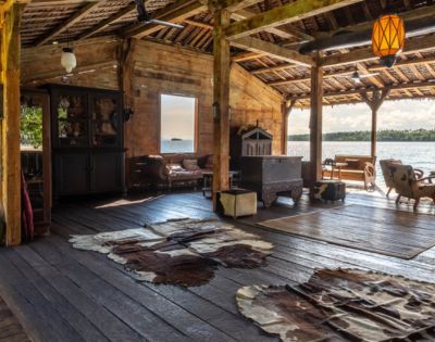 Outdoor lounge space with seating and a scenic view of the ocean.