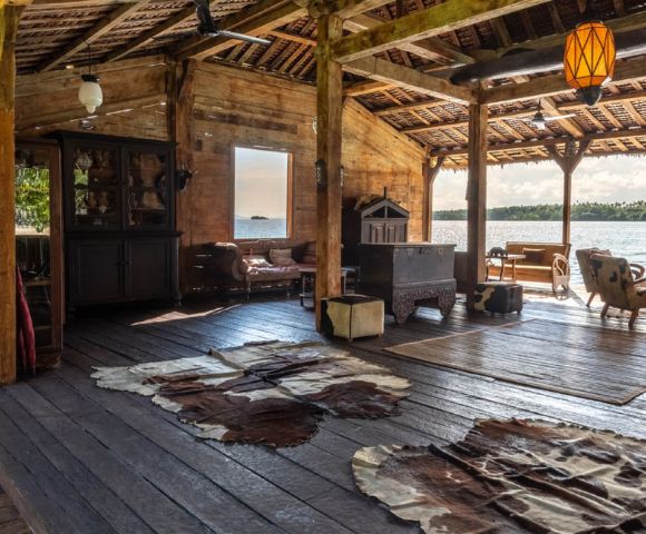 Outdoor lounge space with seating and a scenic view of the ocean.
