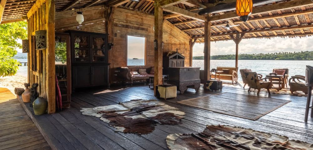 Outdoor lounge space with seating and a scenic view of the ocean.