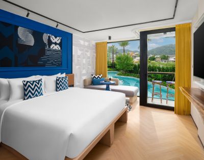 Perspective of the hotel room highlighting its spacious layout and modern decor.