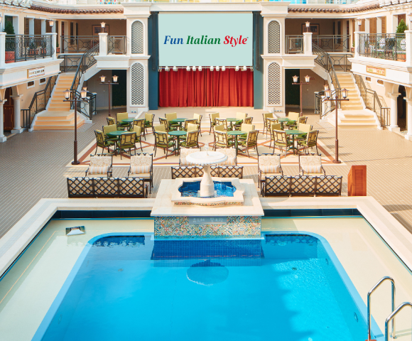 Elegant indoor space featuring an inviting pool, seating area, and a large screen displaying 